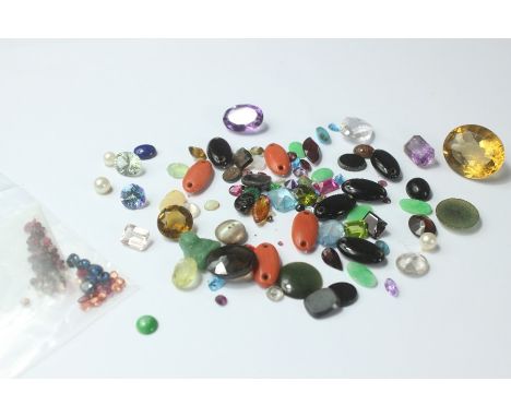 Miscellaneous semi-precious stones, garnet, amethyst, topaz, opal with a quantity of rubies and South African sapphires.