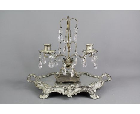 A vintage table lustre, with crystal drops approx 27 cms h, supported on a mirrored rococo style tray, approx&nbsp;37 x 20 cm