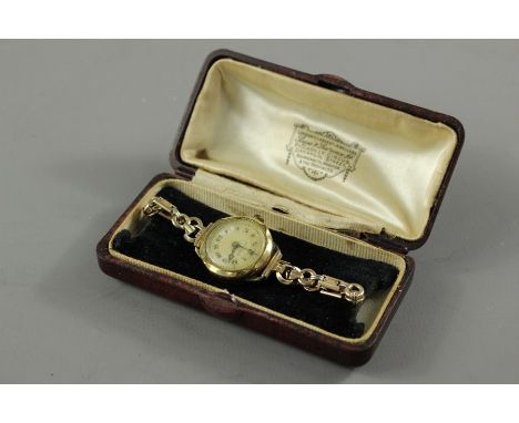 A lady's vintage wrist watch, having a champagne face with numeric dial, stamped shock proof.&nbsp;