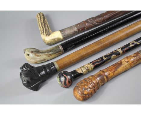 Five vintage walking sticks; including (1) carved stick with bone handle, approx 91 cms l, (2) cloisonne stick depicting a dr