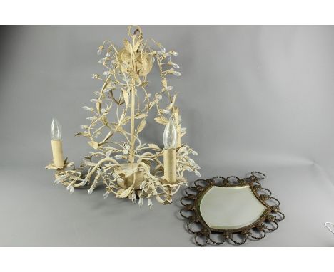 A wrought mirror with decorative circle edge to frame, the bevelled mirror in the shape of a shield, approx 45 x 31 cms toget