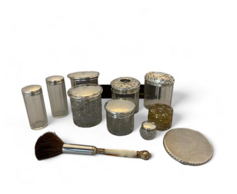 A group of silver and glass dressing table pots, a white metal scent bottle, a bombilla, a silver compact and a cased bakelit