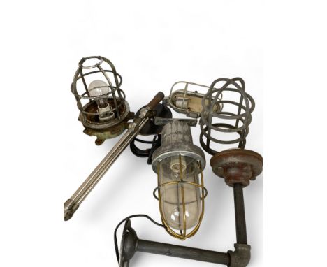 Four various vintage industrial aluminium bulk head lamps Including one by Revo of Tipton, and another with a hinged arm. (4)