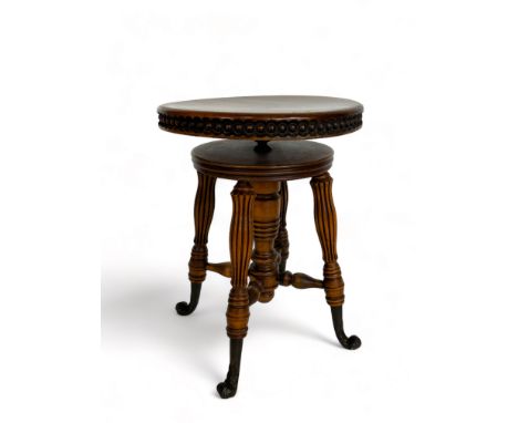 A late 19th century American beechwood circular revolving piano stool by Tonk of New York &amp; Chicago and a&nbsp;Victorian 