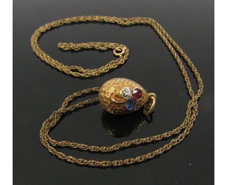 A Russian gold egg pendant set with diamond, ruby and sapphire .20ct each, 2.6g, hung on chain stamped 9ct, 3.1g