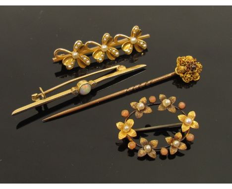 A gold bar brooch with opal flanked by small diamonds stamped 9ct and 15ct, a gold brooch unmarked with three pearl set clove