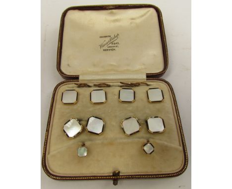 A set of dress studs of canted squares of mother-of-pearl with gold and black enamel line borders (some black enamel missing)