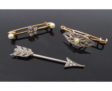 A diamond set "Arrow" tie pin 3.8cm long, 1.8g unmarked with two diamond and pearl bar brooches, one as a pansy, unmarked, 2.