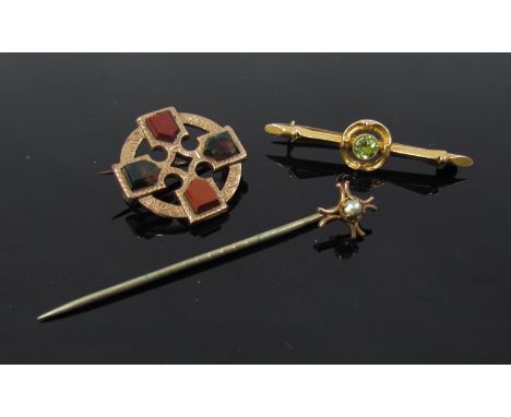 A gold bar brooch with single peridot stamped 15ct, a gold hardstone brooch unmarked and a stick pin with 9ct gold finial, 6g