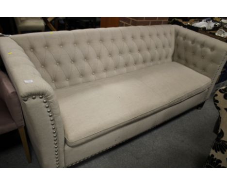 A MODERN UPHOLSTERED BUTTON BACK SOFA