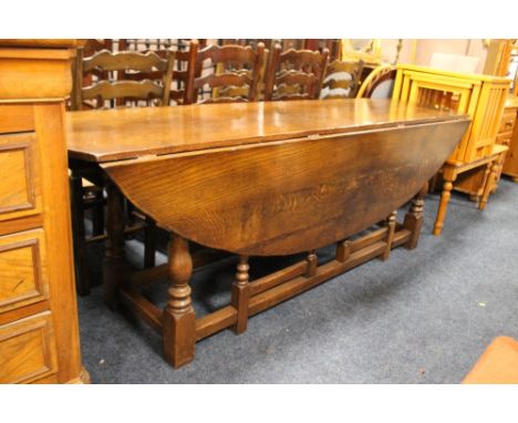 A LARGE OAK WAKE GATE LEG TABLE  H - 75 W - 228 CM