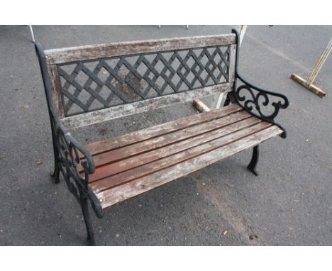 A GARDEN BENCH WITH CAST LEGS AND BACK