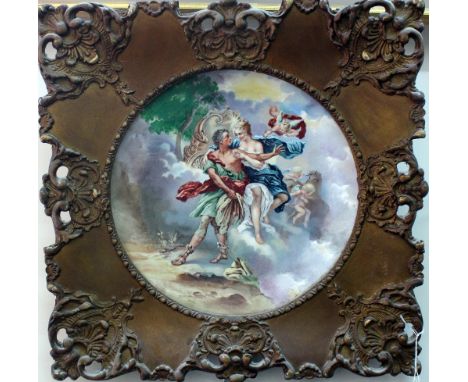 A pair of continental ceramic wall plates, circa 1900, decorated with classical figural scenes, in ornate foliate carved gilt