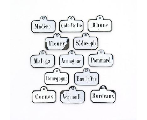 Thirteen Continental enamel bin labels, 19th/early 20th century, of chamfered rectangular form, variously inscribed in black 