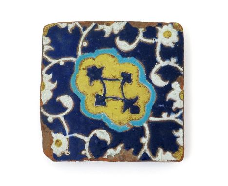 A cuerda seca square tile, 16th century, probably Safavid, decorated with a central panel banded in turquoise and containing 