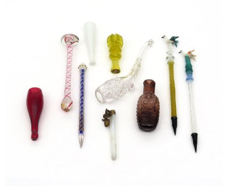 A small collection of glass toys and trinkets, 19th century and later, including an amethyst glass scent bottle moulded with 