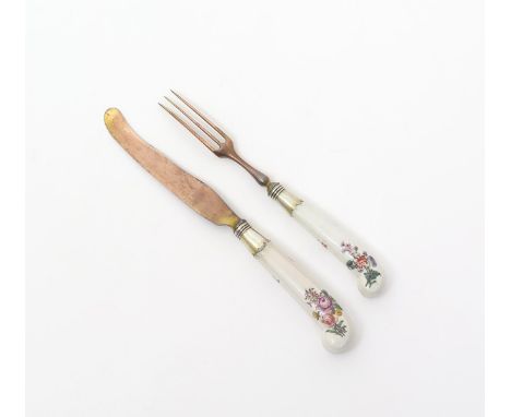 A good Chelsea dessert knife and fork, c.1753, the moulded pistol hafts finely painted with polychrome flower sprays on a whi