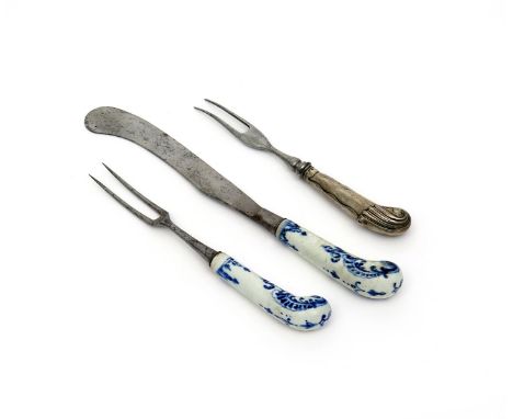 A Bow knife and fork, c.1755, the pistol grip hafts painted in underglaze blue with shell scrolls and foliate tendrils, and a