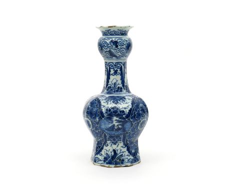 A tall Delft vase, early 18th century, of octagonal baluster form, painted with three small panels of a figure in a sampan, o