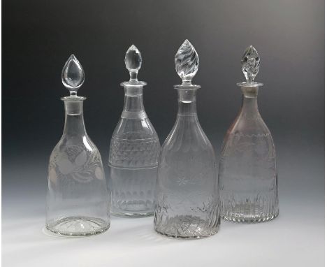 Three moulded glass decanters and stoppers, c.1800, one with spiral flutes and engraved 'Rne Bi' above a star, another two wi