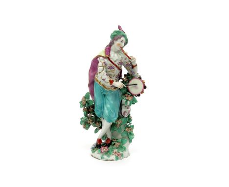 A Chelsea figure of a musician, c.1762, playing the flageolet with his left hand and banging on a tabor with his right, weari