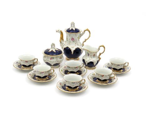 A Meissen coffee service, modern, painted with small polychrome flower sprays within moulded rococo panels reserved on a rich