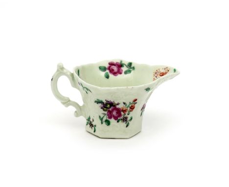 A good Worcester hexagonal creamboat, c.1755, moulded with scroll panels and a large geranium leaf to the underside of the sp