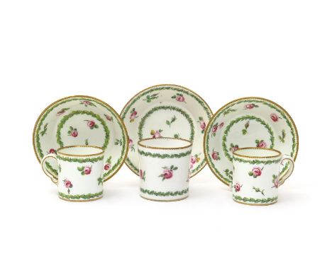 Three Sèvres coffee cans and saucers, date codes for 1775 and 1781, painted with small sprigs of flowering pink roses within 