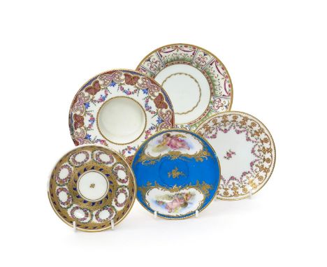 Five Sèvres and Sèvres-style saucers, 18th and 19th centuries, variously painted with flower wreaths and swags within formal 