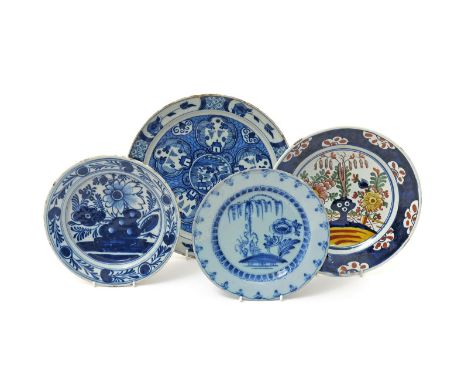 Three Delft plates, 18th century, variously painted in blue and polychrome enamels with Chinese landscape and garden scenes, 