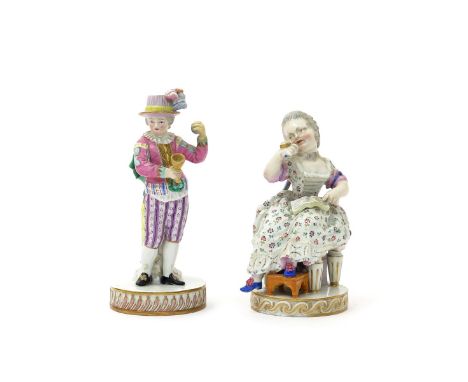 Two Meissen figures of children, 19th century, one of a boy playing with a cup and ball and wearing a plumed hat, the other o