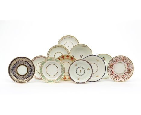 Eleven Derby saucers, c.1800-25, variously decorated with gilt flower sprigs, continuous flower garlands and formal scrolls, 
