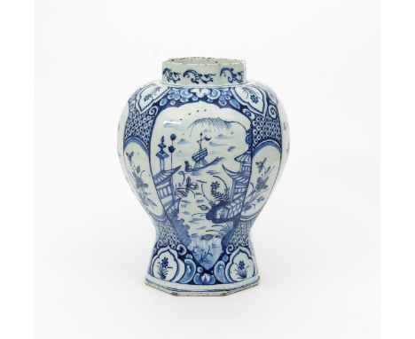 A large Delft vase, 18th century, of octagonal baluster form, painted in blue with panels of boats in pagoda landscapes and b