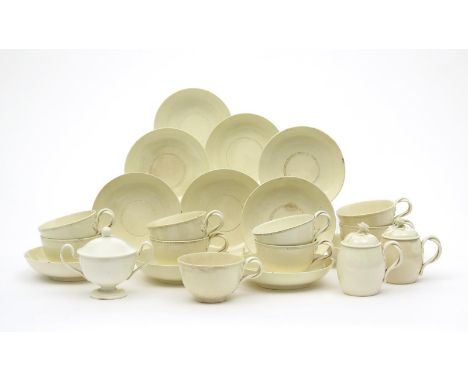 Nine creamware cups and eleven saucers, late 18th/early 19th century, moulded with narrow beaded borders, the cups with doubl