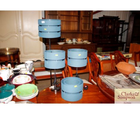 A teal standard lamp, a pair of matching table lamps, and a spare shade 