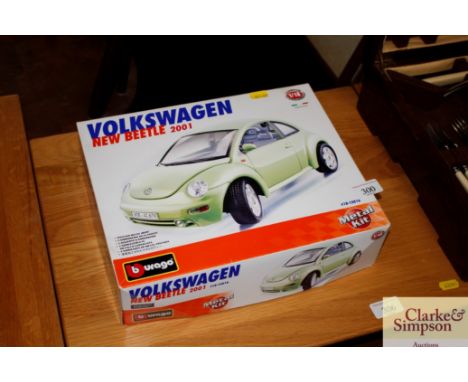 A boxed Burago Volkswagen Beetle metal kit 