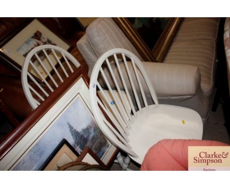 A pair of white stick back dining chairs 
