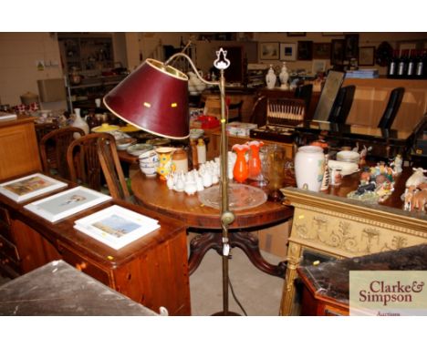 An adjustable brass standard lamp and shade 