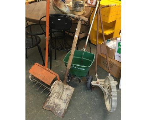 Several garden tools including a scarifier, shovel, and tiller 