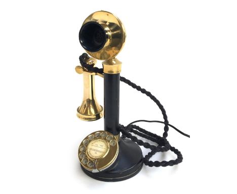 A vintage rotary dial candlestick telephone, wired to work 