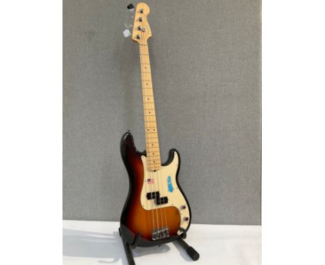 A Fender Precision Bass guitar, made in USA, three tone sunburst body, serial number Z5136641, circa 2005, with fitted Fender