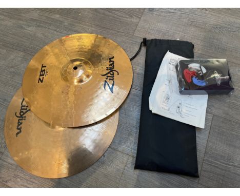 A pair of Zildjian ZBT hi hat cymbals together with sticks and associated fittings 