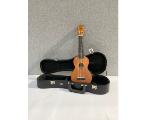 A Mahalo ukulele of guitar form with fitted hard case 