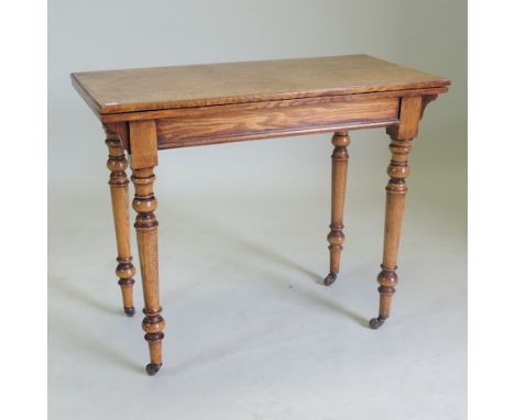 A Victorian oak folding rectangular folding card table, on turned legs, 91cm