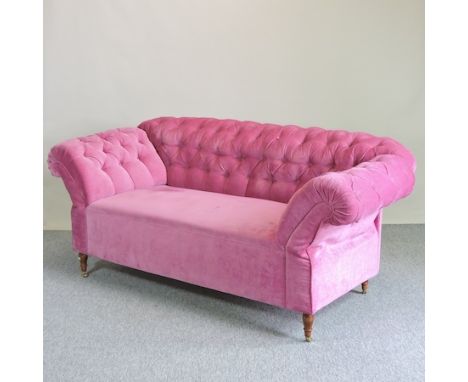 A pink dralon upholstered button back drop end Chesterfield sofa, on turned legs and castors, 192cm