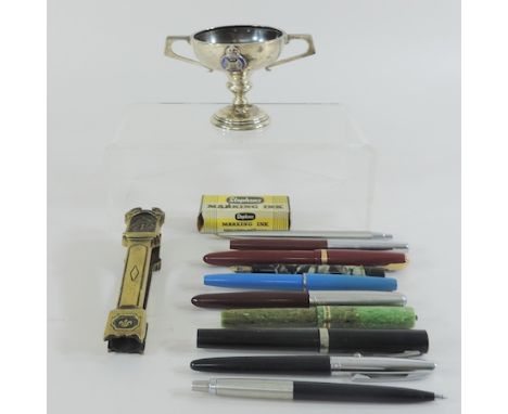 A small silver trophy cup, together with a collection of pens and a brass door knocker in the form of a clock