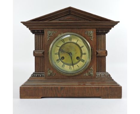 A 1920's oak mantel clock, with an eight day movement, 36cm tall