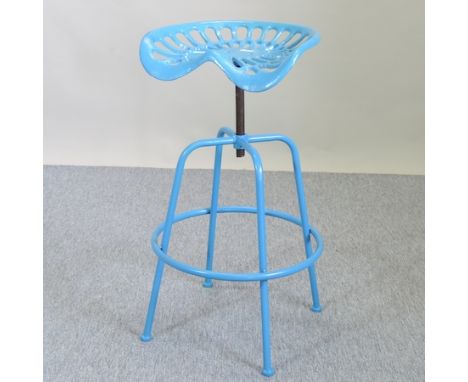 A blue painted metal tractor seat bar stool