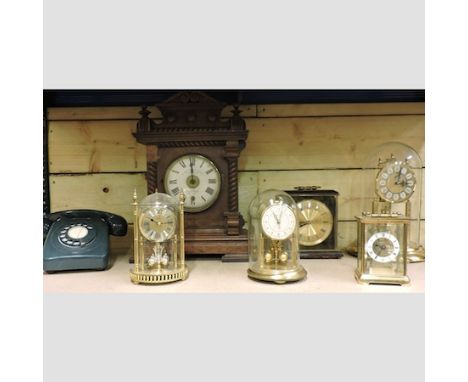 A 19th century walnut cased Bradford electric alarm clock, 42cm tall, together with five various mantel clocks and a vintage 