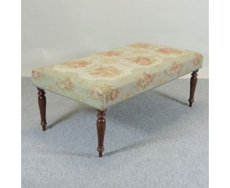 A large tapestry upholstered footstool, on turned legs, 128cm